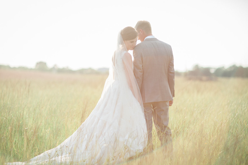 Southern Elegance at Beckendorff Farms Bride and groom in feild