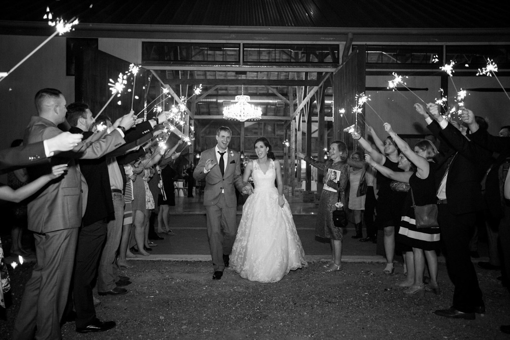 Southern Elegance at Beckendorff Farms bride and groom walking through sparkler tunnel