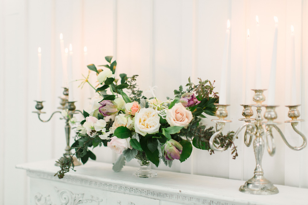 Spring Bridals at the Farmhouse fireplace with floral arrangement and candles