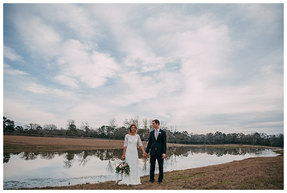First Wedding at The Farmhouse couple standing at water edge