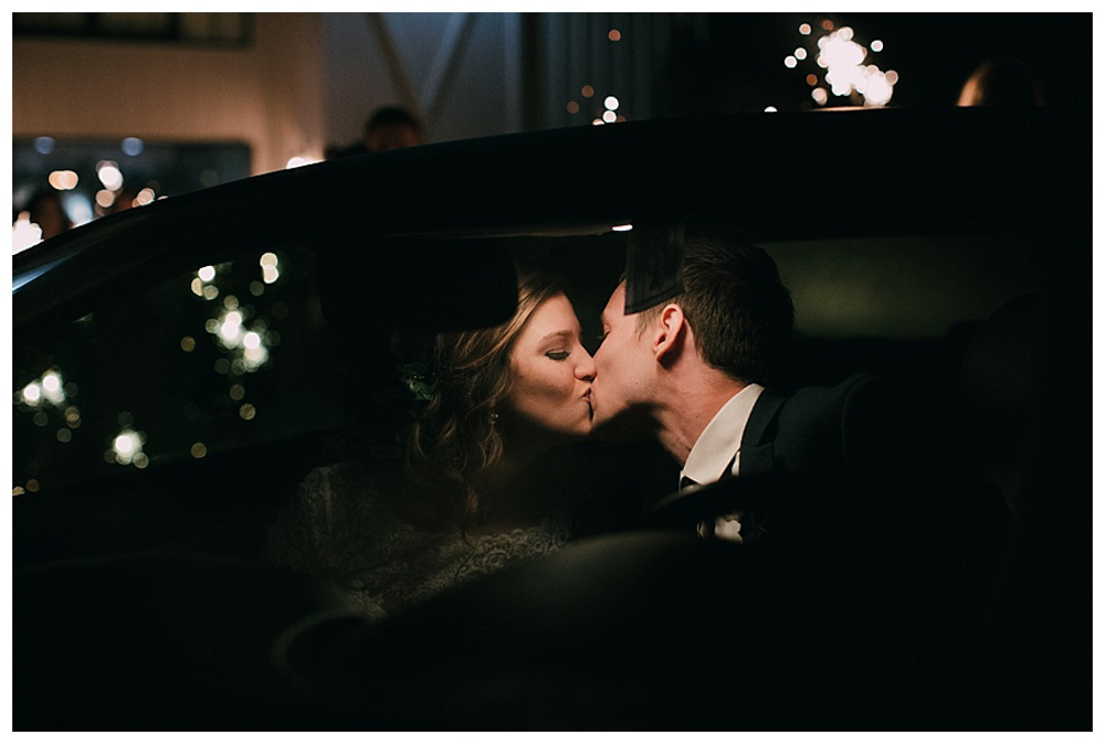 First Wedding at The Farmhouse bride and groom kissing in limo
